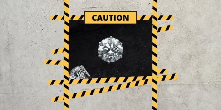 a caution sign featuring a diamond symbolising the need to use caution when buying a diamond