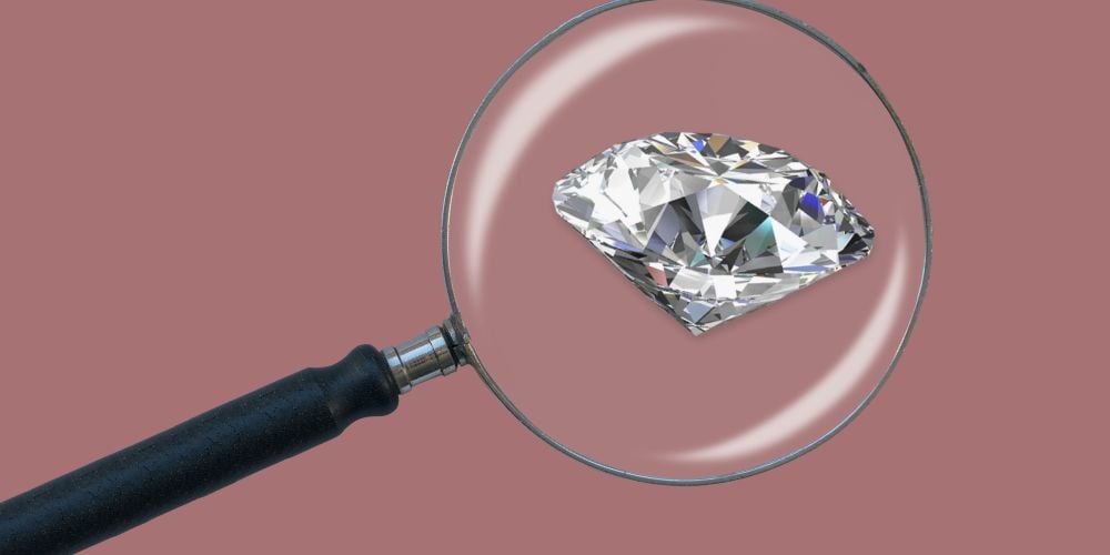 image showing a diamond under a magnifying glass 